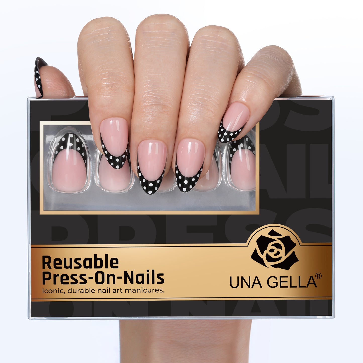 Medium pink press-on nails with black French tips featuring white polka dots, soft gel finish.