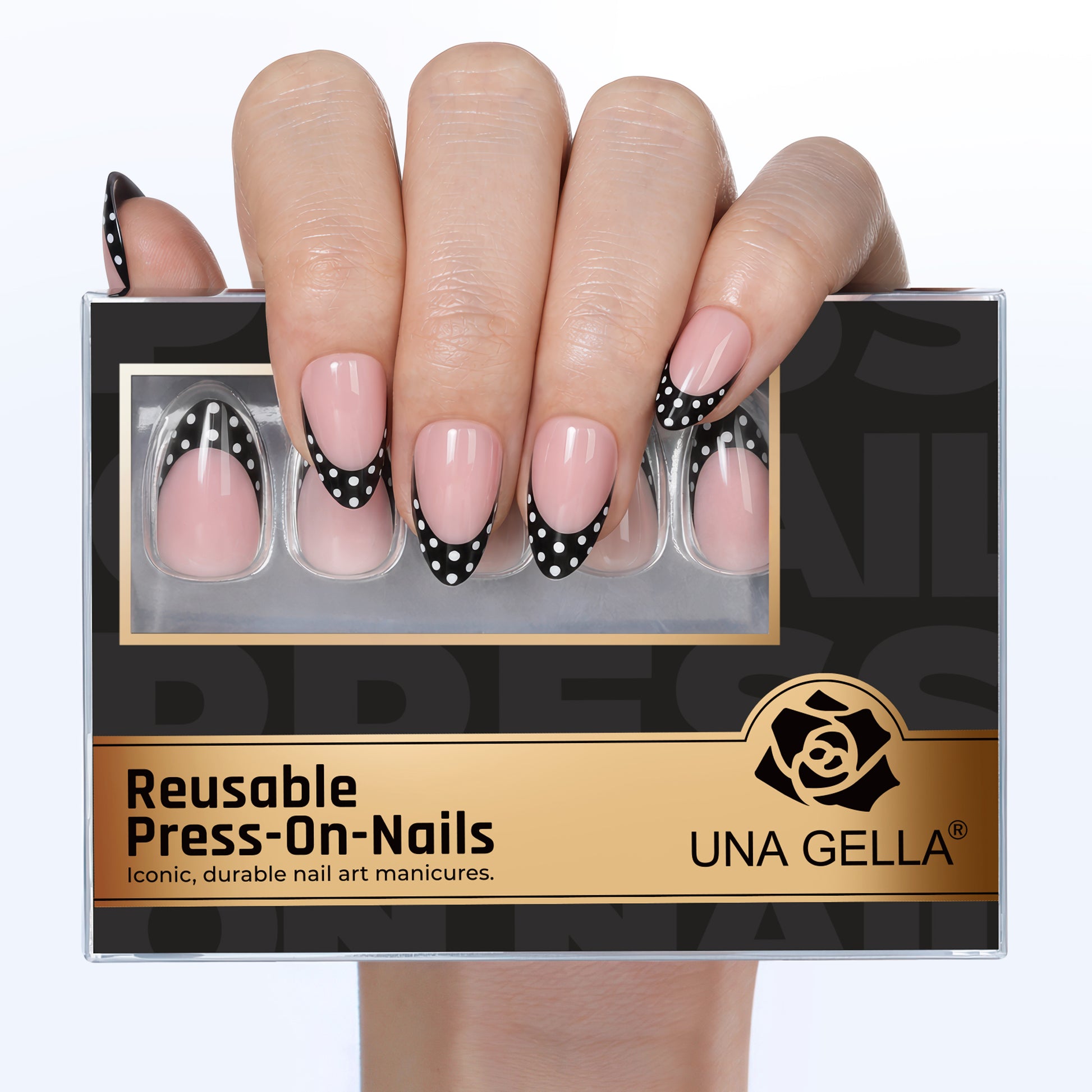 Medium pink press-on nails with black French tips featuring white polka dots, soft gel finish.