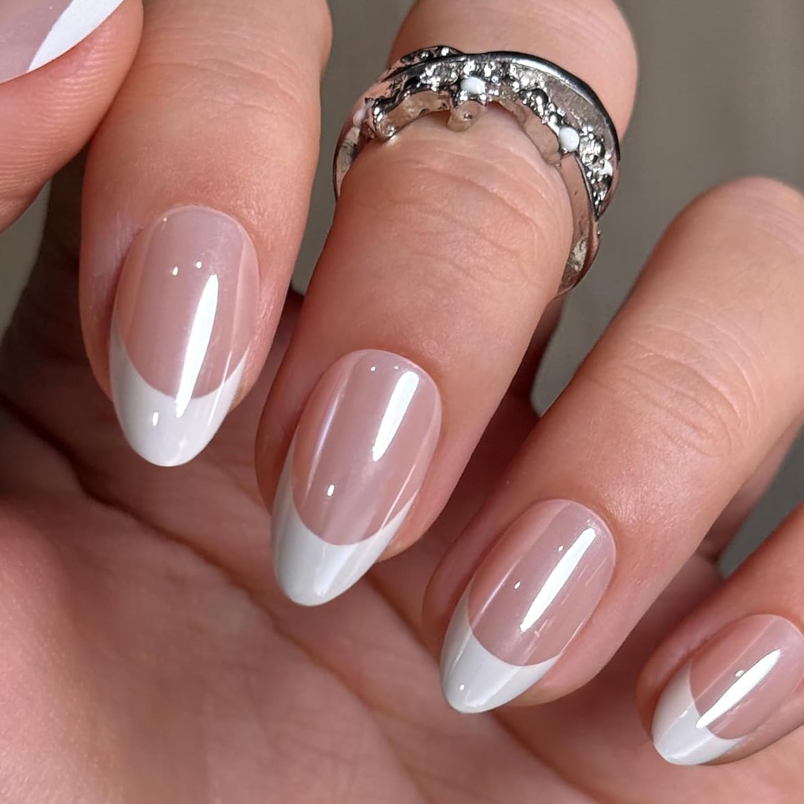 Almond-shaped short French soft gel press-on nails by UNA GELLA, reusable nail tips with natural finish.