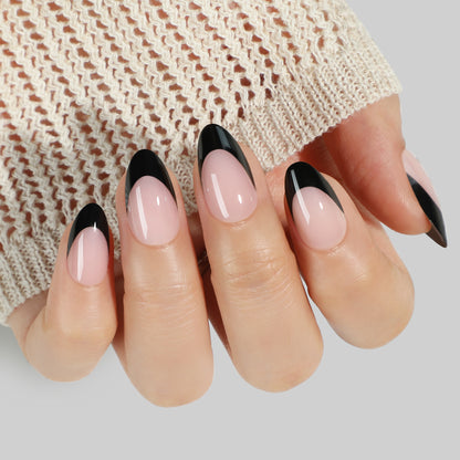 Black French tip press-on nails in almond shape by UNA GELLA, short soft gel reusable nail tips shown on a white background.