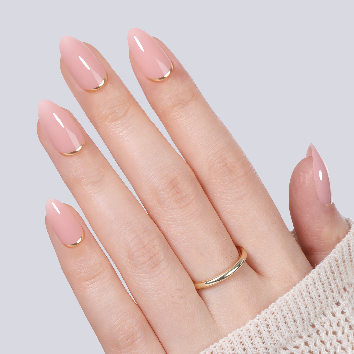 UNA GELLA nude pink almond-shaped press-on nail tips with gold rim, 16 sizes, designed for easy application and natural look.