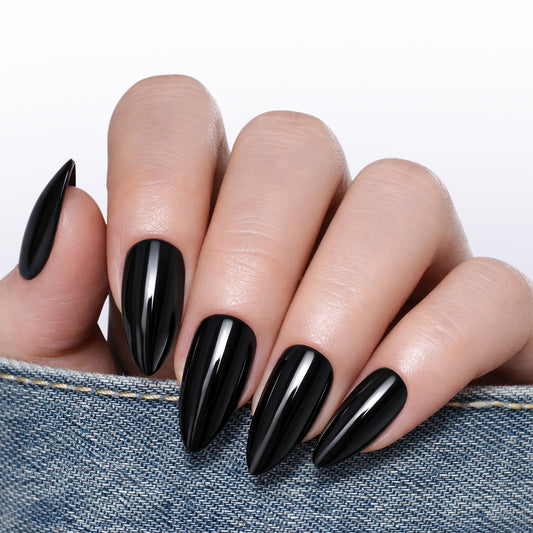 Medium almond-shaped black press-on nail tips by UNA GELLA, reusable soft gel, 32-piece set for DIY manicure.
