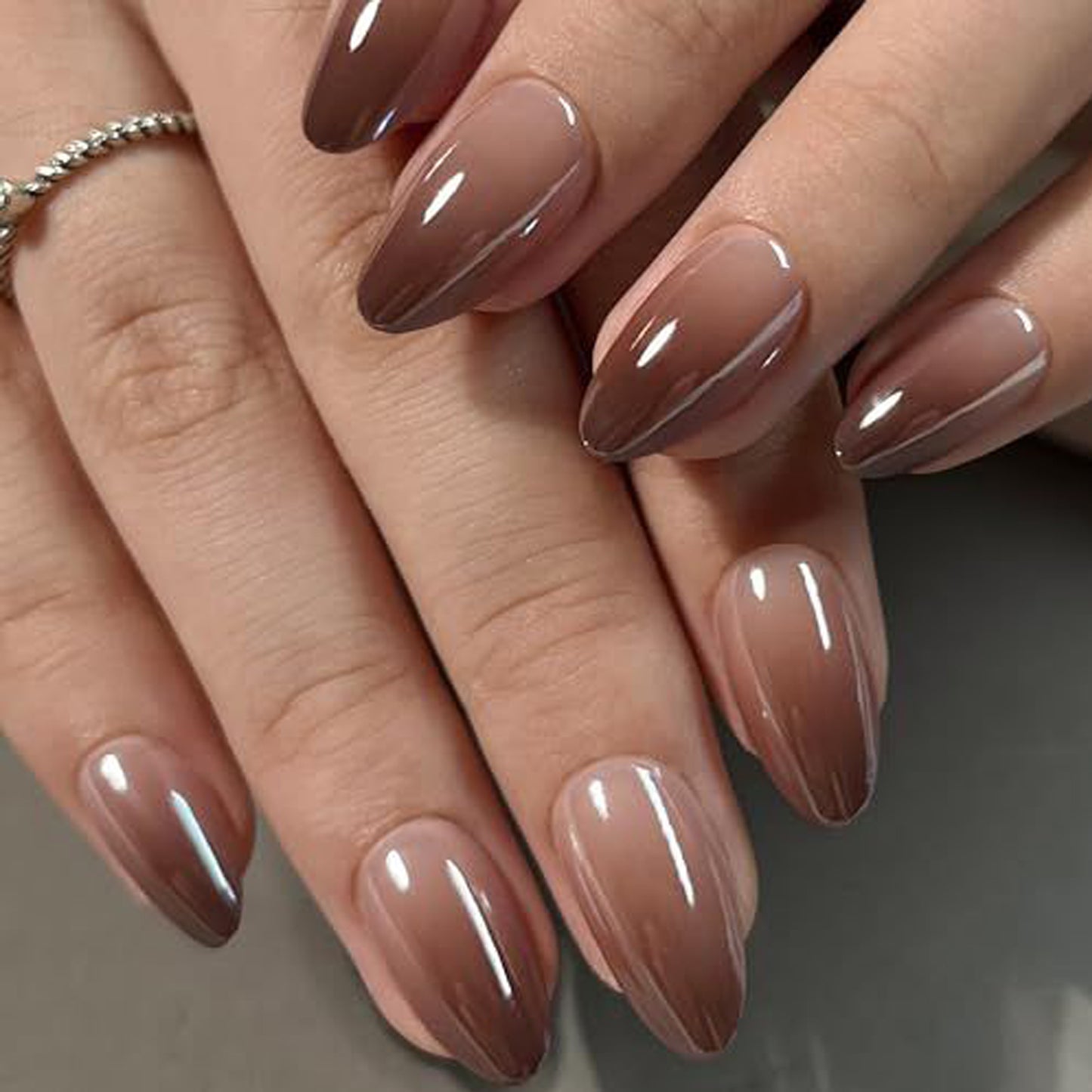 Brown metallic gradient reusable press-on nail tips in almond shape by UNA GELLA, short and stylish for DIY nail designs.