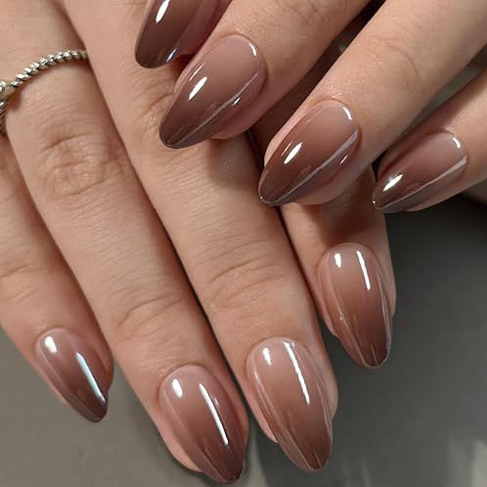 Brown metallic gradient reusable press-on nail tips in almond shape by UNA GELLA, short and stylish for DIY nail designs.