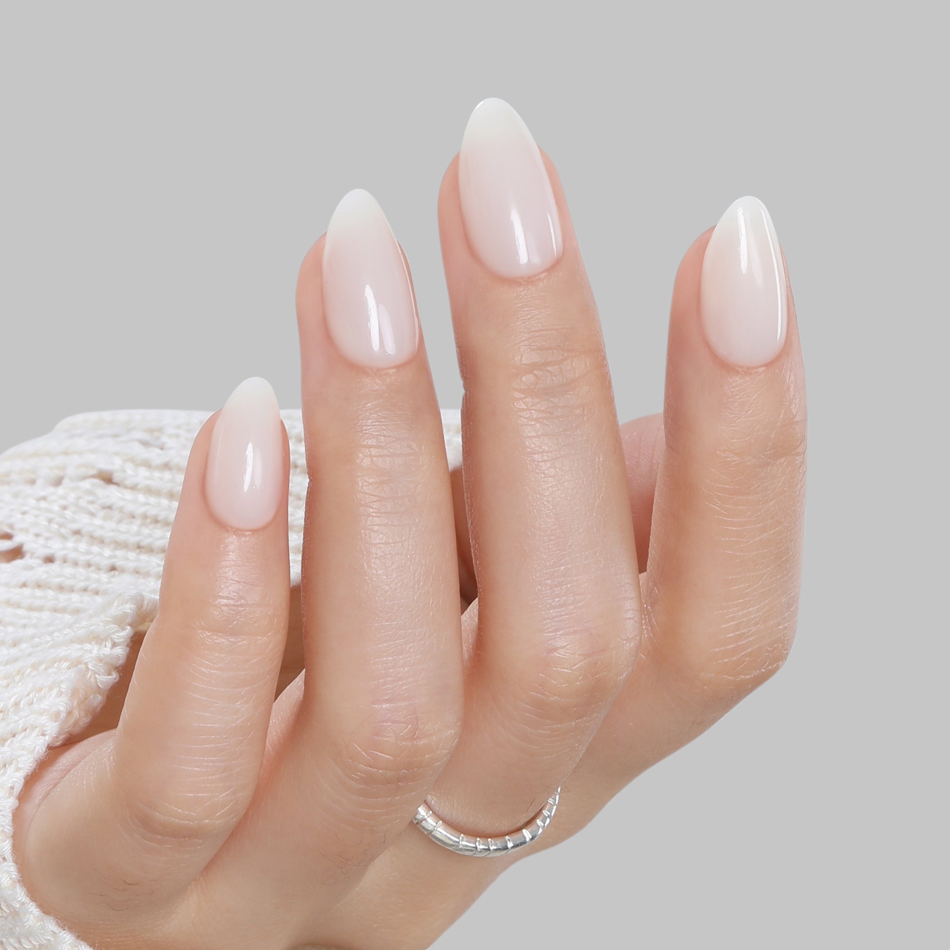 Milky white almond-shaped press-on nails by UNA GELLA, short soft gel nail tips, reusable with 16 sizes for easy application.