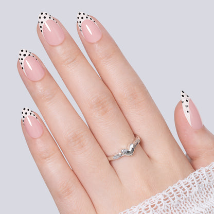 Set of 32 UNA GELLA polka dot French almond-shaped press-on nails with black polka dots on soft gel tips.