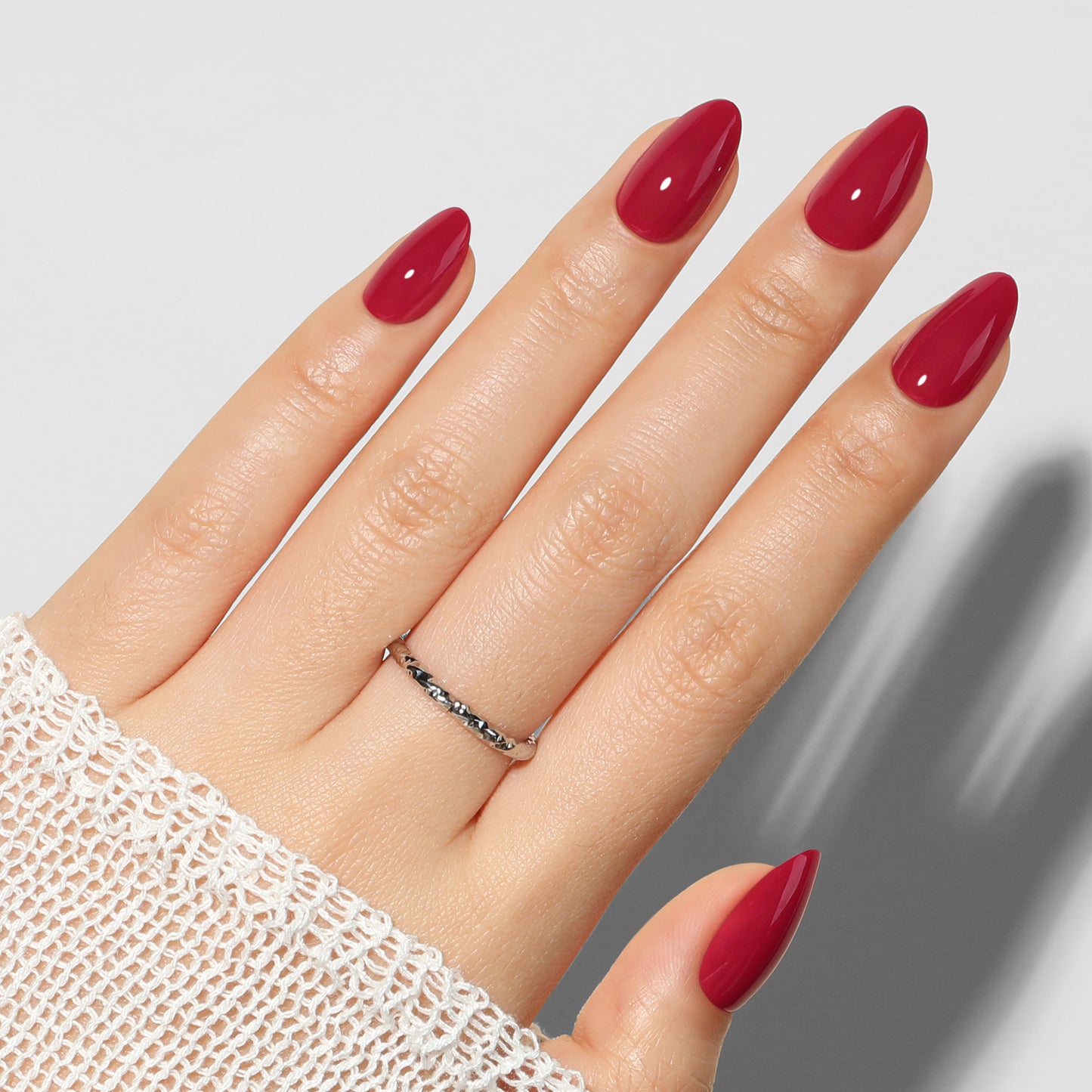 UNA GELLA Red Almond Press On Nails, soft gel nail tips in a 32-piece set with 16 sizes, shown on a nail display.