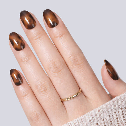 UNA GELLA 32-piece set of reusable soft gel press-on nail tips in tortoise shell pattern with 16 sizes.