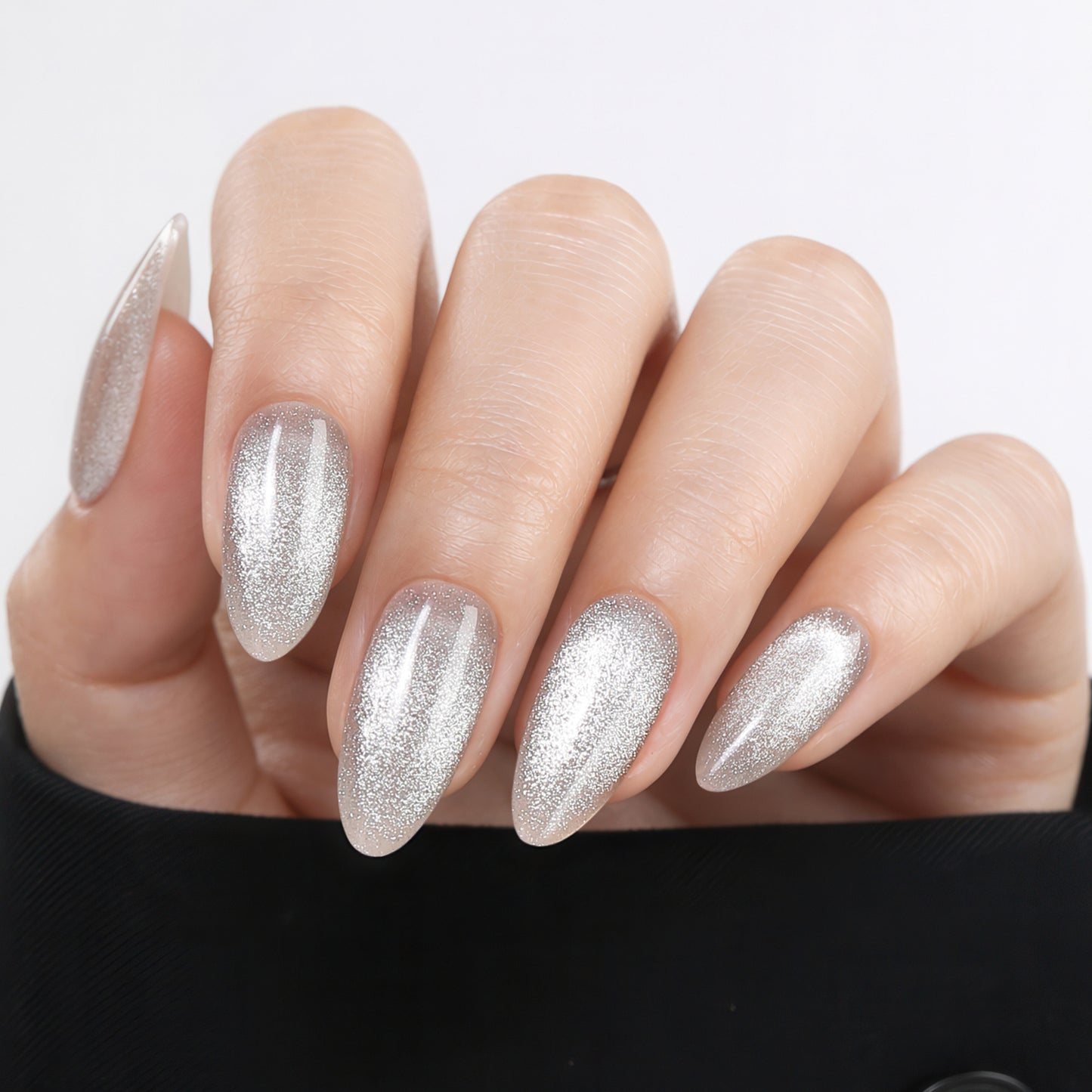 Silver cat eye almond-shaped press-on nails by UNA GELLA, 32-piece set with 16 sizes, reusable soft gel nail tips for DIY manicure.