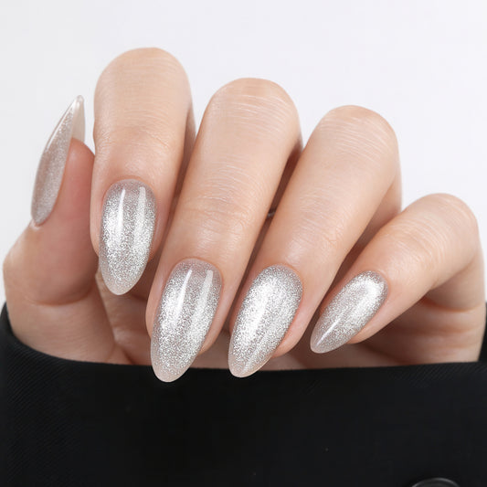 Silver cat eye almond-shaped press-on nails by UNA GELLA, 32-piece set with 16 sizes, reusable soft gel nail tips for DIY manicure.