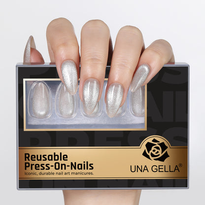 Silver cat eye almond-shaped press-on nails by UNA GELLA, 32-piece set, reusable soft gel nail tips in 16 sizes for DIY manicures.
