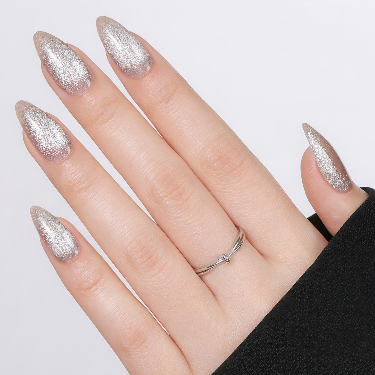 Silver cat eye almond-shaped press on nails by UNA GELLA, 32-piece set with 16 sizes, reusable soft gel nail tips for DIY manicure.