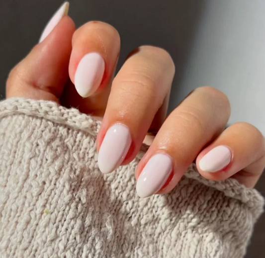 White almond-shaped press-on nails by UNA GELLA featuring salon-grade reusable gel finish.