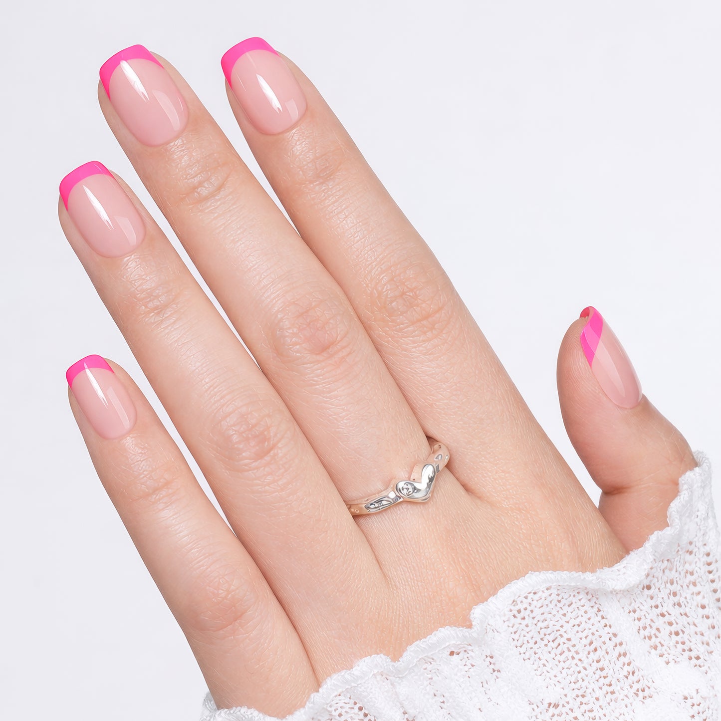 Bright pink French press-on nails by UNA GELLA, short squoval soft gel reusable nails, perfect for DIY manicures.