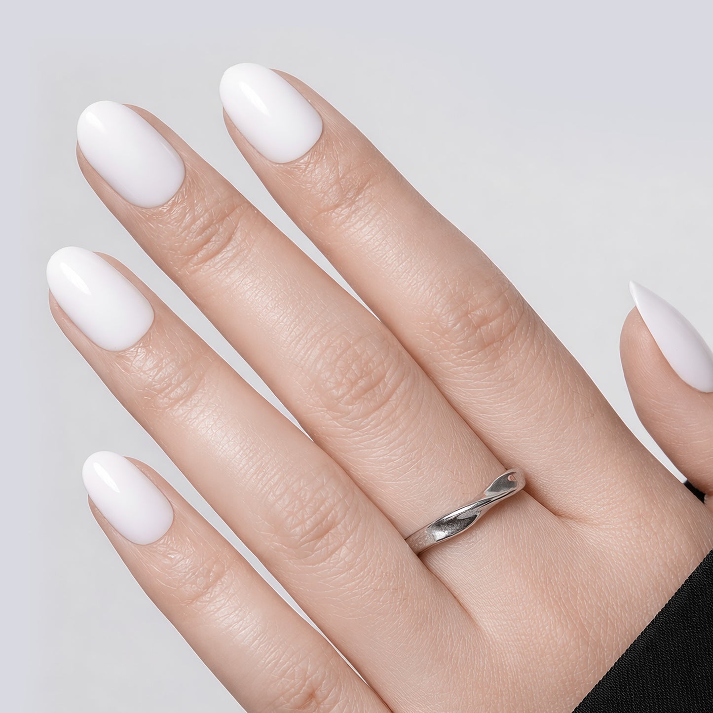 Set of 32 white oval press-on nails in 16 sizes, reusable soft gel squoval nails by UNA GELLA for DIY nail designs.