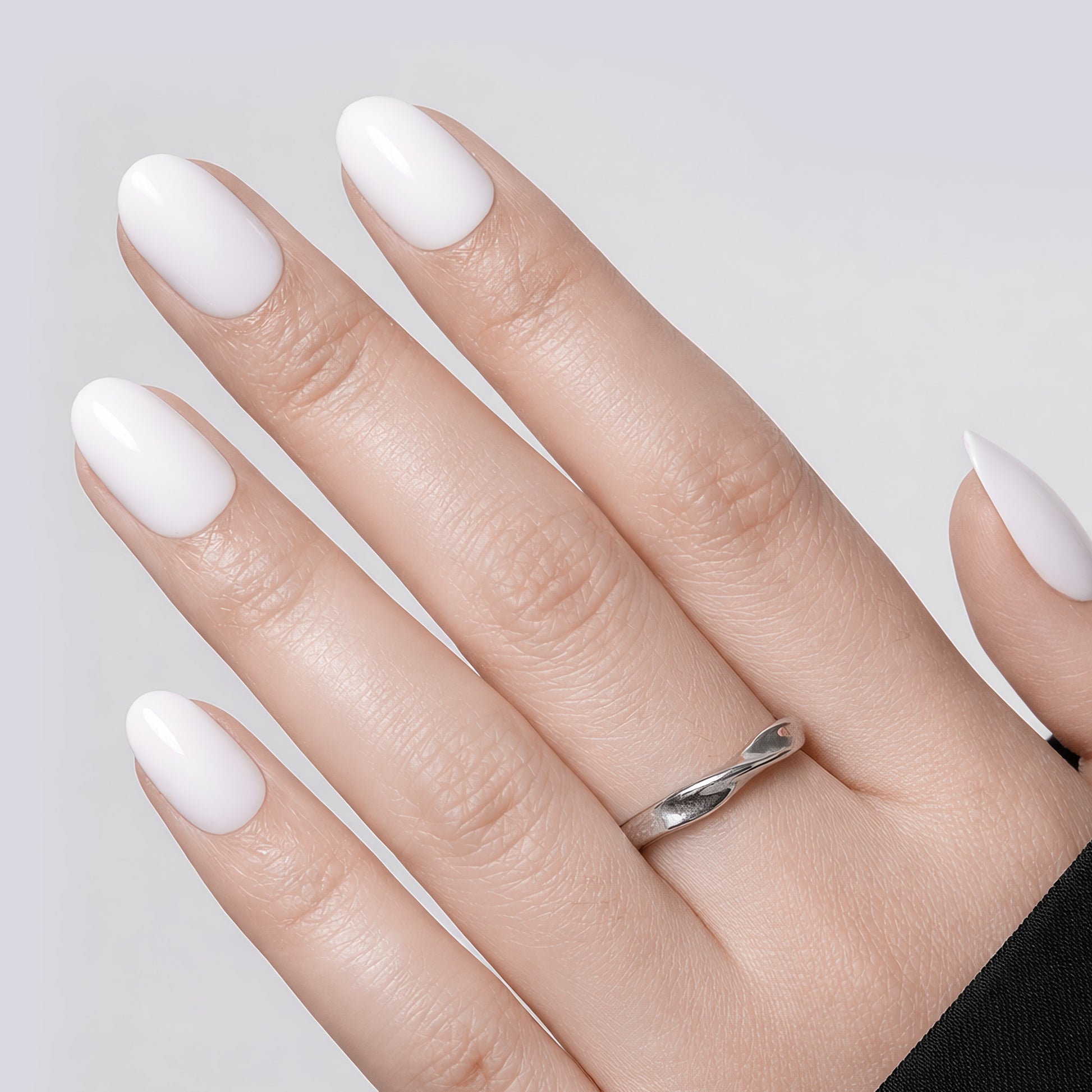 Set of 32 white oval press-on nails in 16 sizes, reusable soft gel squoval nails by UNA GELLA for DIY nail designs.
