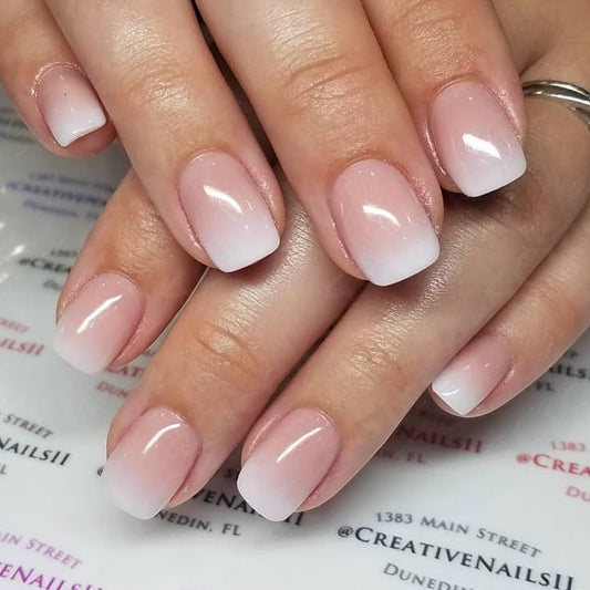 UNA GELLA squoval soft gel press-on nails in nude cream ombre, 32-piece set with reusable short square design.